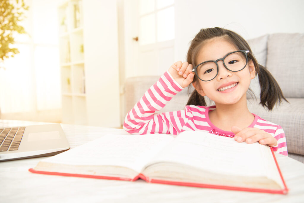 Happy,Child,Little,Asian,Girl,Smile,With,Holding,Glasses,Reading