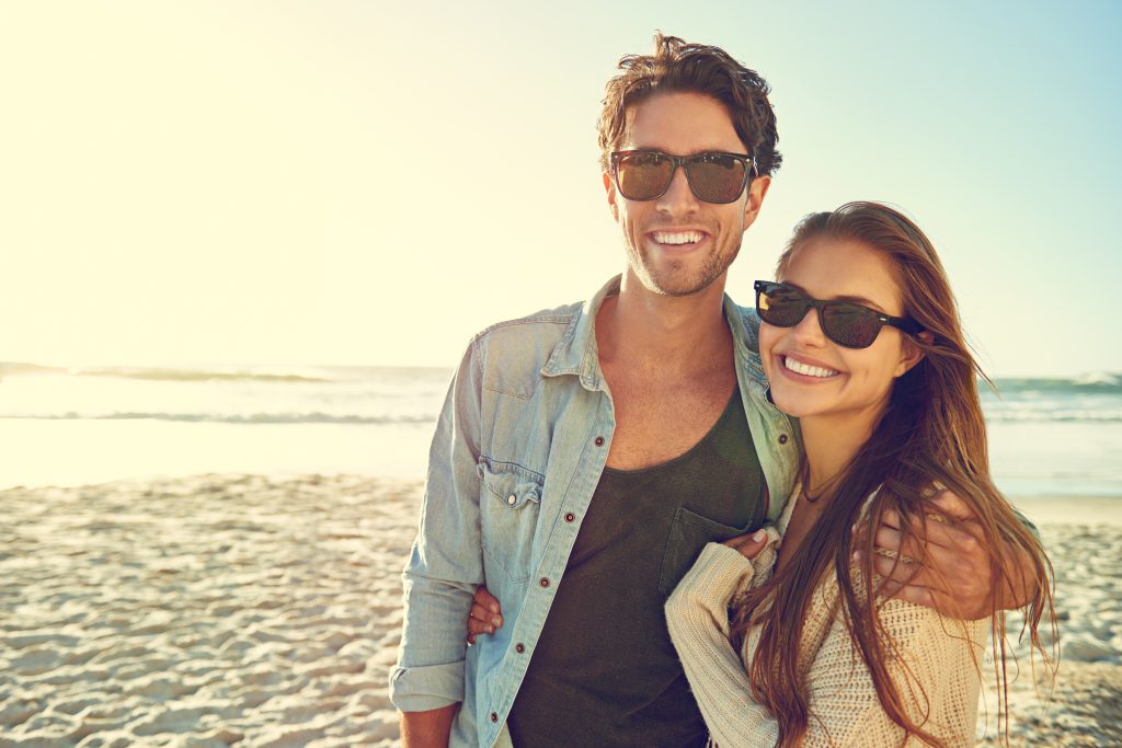 Couple,,Ocean,And,Sunglasses,With,Hug,,Happy,Or,Care,For